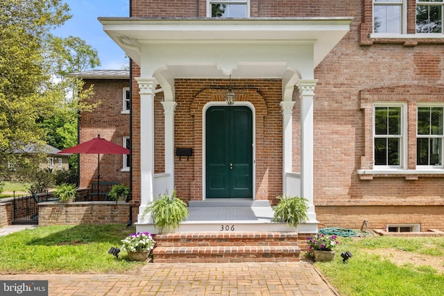 doorway to property with brick siding