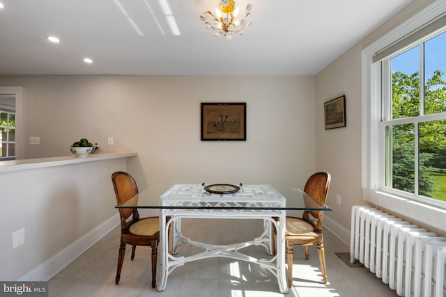 dining space with radiator heating unit, baseboards, recessed lighting, a chandelier, and tile patterned flooring