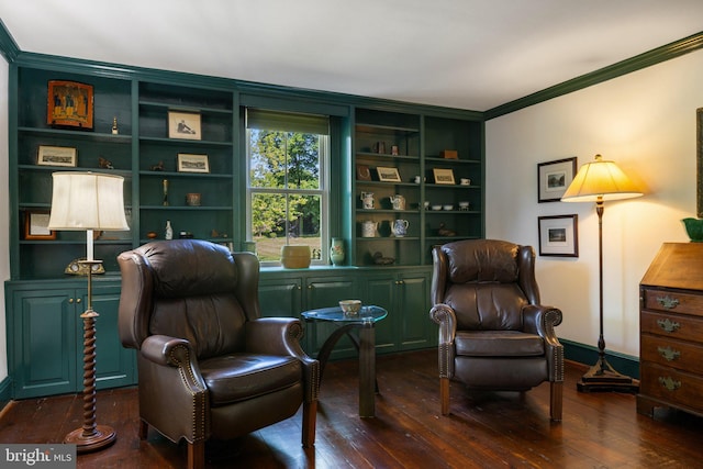living area featuring hardwood / wood-style floors, ornamental molding, built in features, and baseboards