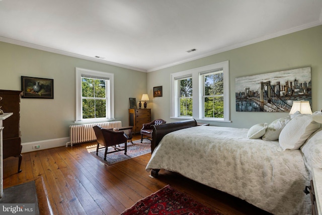 bedroom featuring radiator, wood-type flooring, baseboards, and ornamental molding