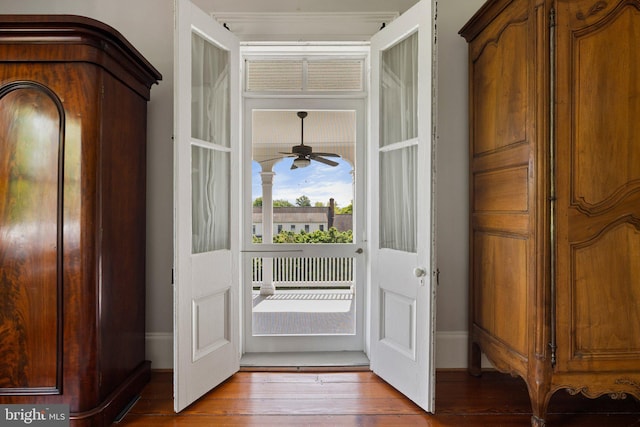 foyer entrance with wood finished floors, ceiling fan, and baseboards