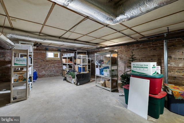 basement featuring brick wall