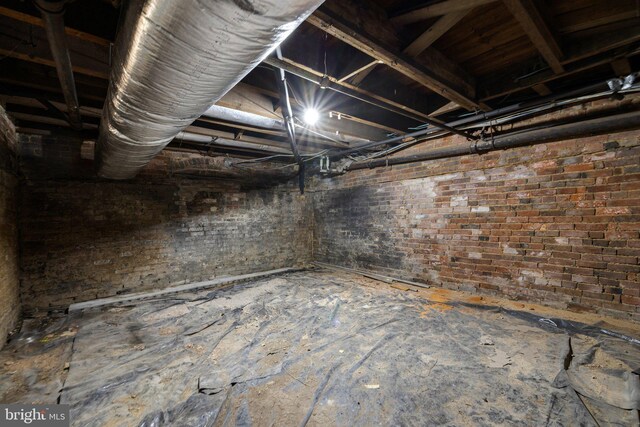 below grade area featuring brick wall