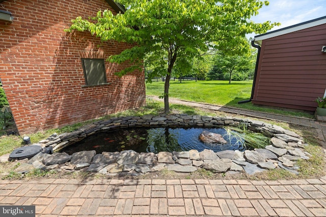 exterior view of a garden pond and brick siding