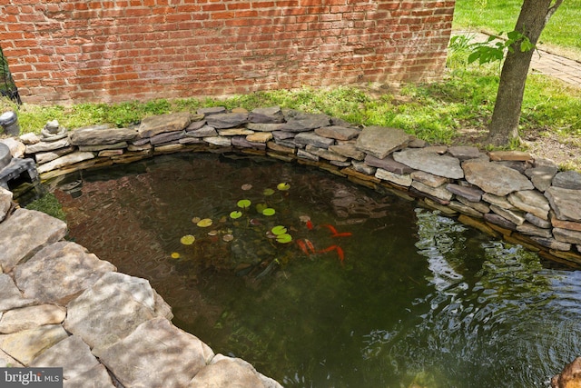 exterior view of a garden pond and brick siding