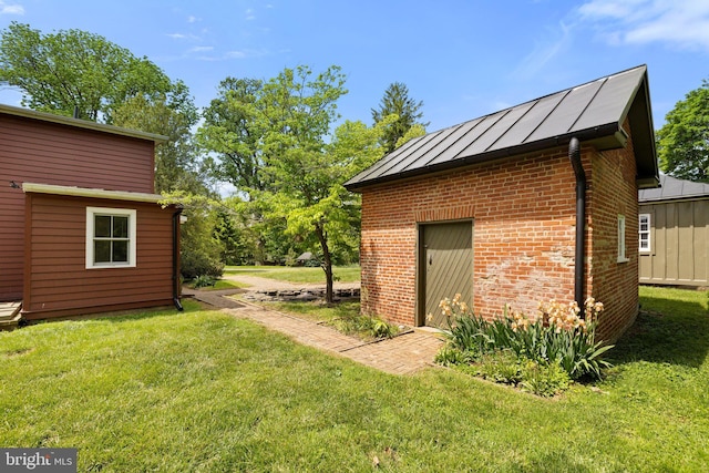 view of green lawn with an outbuilding