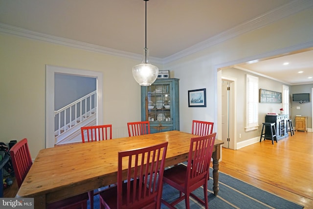 dining room with recessed lighting, ornamental molding, stairs, and hardwood / wood-style flooring