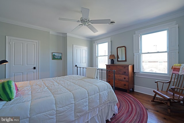 bedroom with crown molding, baseboards, ceiling fan, and hardwood / wood-style flooring