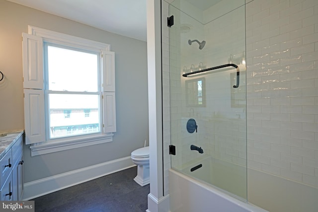 bathroom with plenty of natural light, baseboards, toilet, and vanity