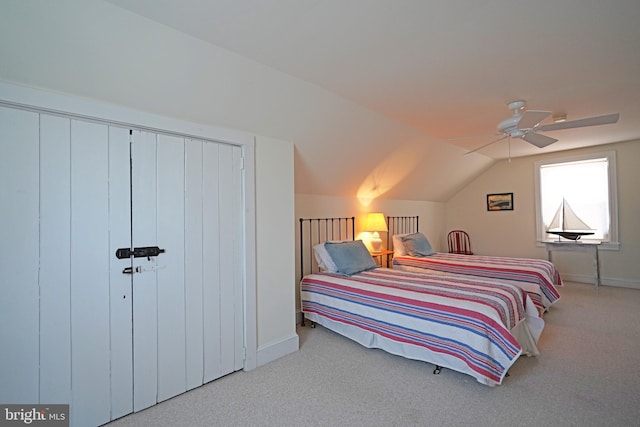 carpeted bedroom featuring baseboards, vaulted ceiling, and ceiling fan