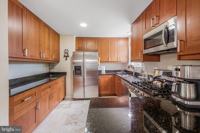 211 N Huron Dr, Oxon Hill, MD 20745 - kitchen featuring stainless steel appliances, a sink, dark stone counters, brown cabinets, and recessed lighting