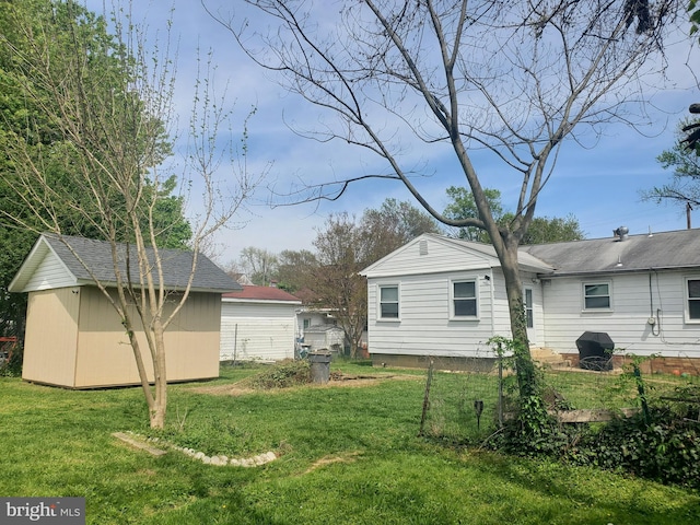 view of yard featuring a storage shed and an outbuilding