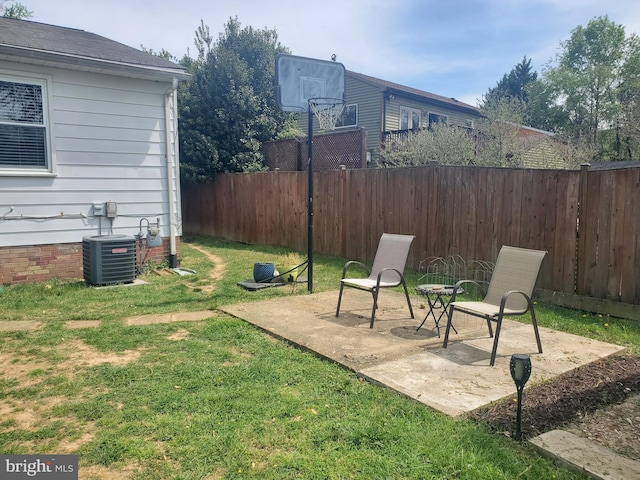 view of yard with central AC unit, a fenced backyard, and a patio area