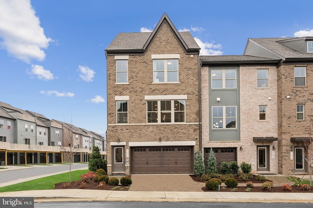 townhome / multi-family property featuring a residential view and brick siding