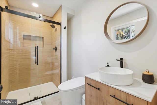 full bath featuring vanity, a shower stall, toilet, and recessed lighting