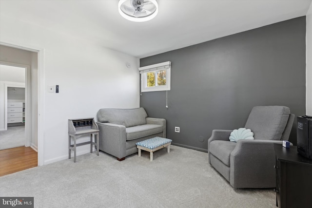 living area with baseboards and carpet floors
