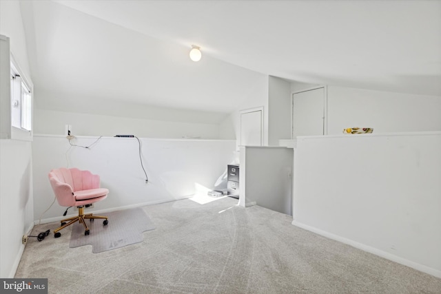 unfurnished room featuring baseboards, carpet floors, and vaulted ceiling