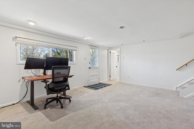 carpeted home office featuring plenty of natural light and baseboards