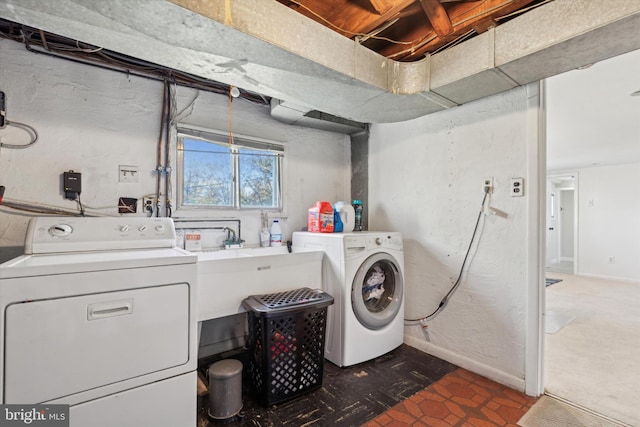 laundry area featuring washing machine and dryer and baseboards
