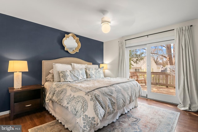 bedroom featuring baseboards, wood finished floors, a ceiling fan, access to exterior, and an accent wall