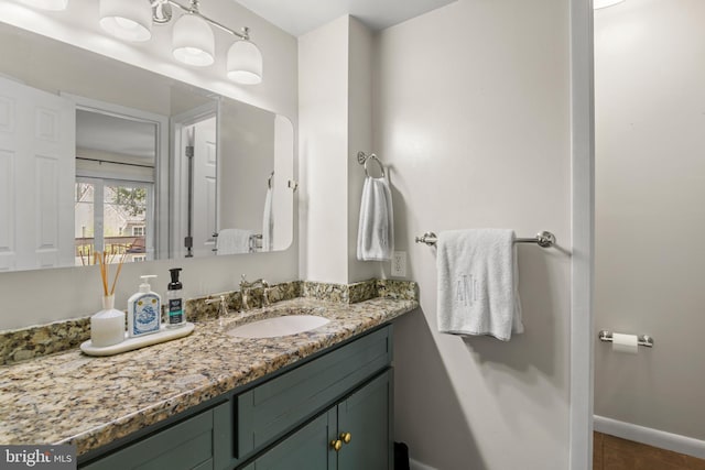 bathroom with baseboards and vanity
