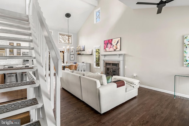 living room with dark wood finished floors, a fireplace, high vaulted ceiling, and stairway