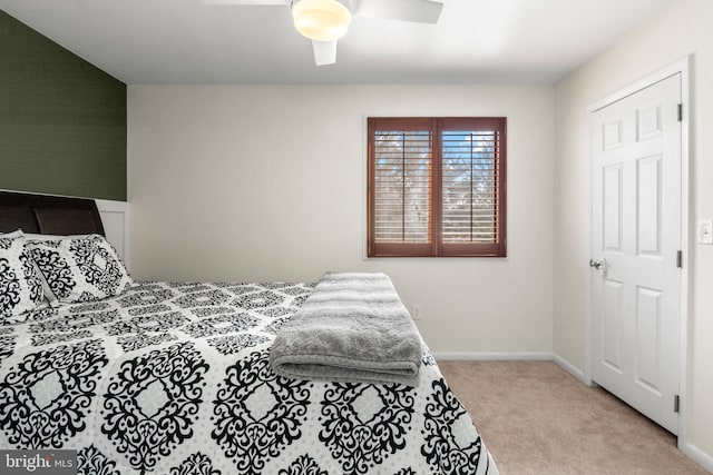 bedroom with a ceiling fan, carpet, and baseboards