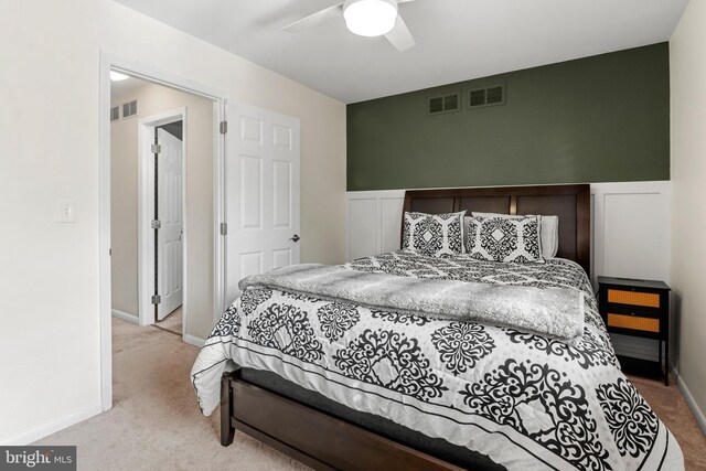 bedroom with visible vents, carpet flooring, and a ceiling fan