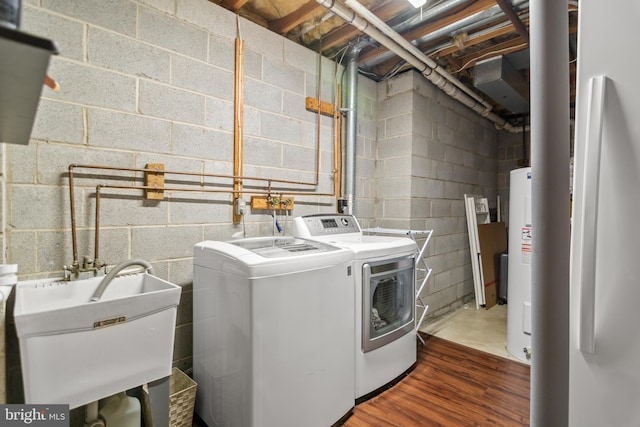 washroom featuring a sink, washer and clothes dryer, laundry area, and dark wood finished floors