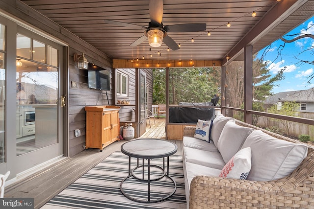 sunroom with an outdoor hangout area and ceiling fan