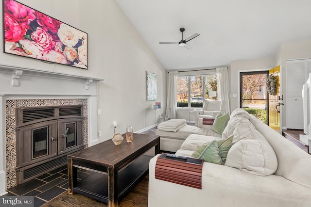 living area with baseboards, vaulted ceiling, wood finished floors, and a ceiling fan