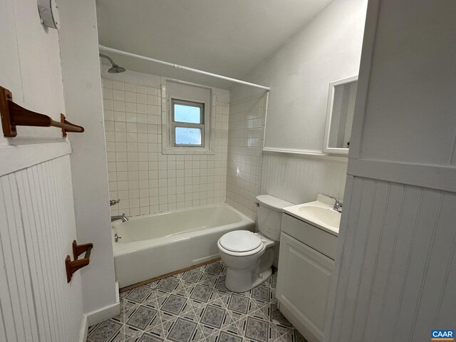 1616 Mulberry Ave, Charlottesville, VA 22903 - bathroom with toilet, tile patterned flooring, washtub / shower combination, wainscoting, and vanity