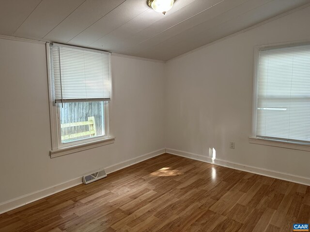 1616 Mulberry Ave, Charlottesville, VA 22903 - spare room with visible vents, baseboards, wood finished floors, and ornamental molding