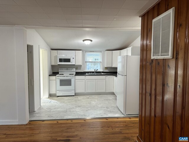 1616 Mulberry Ave, Charlottesville, VA 22903 - kitchen with a sink, dark countertops, white cabinetry, white appliances, and light wood finished floors