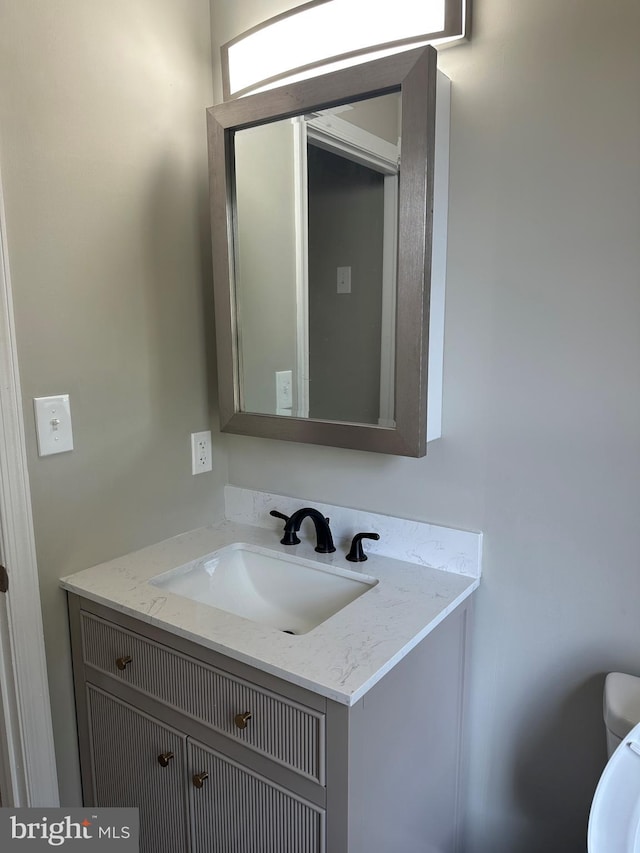 bathroom featuring vanity and toilet