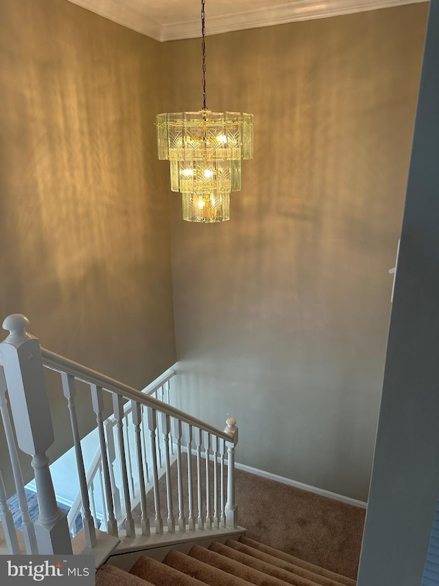 stairs featuring baseboards, a notable chandelier, ornamental molding, and carpet flooring