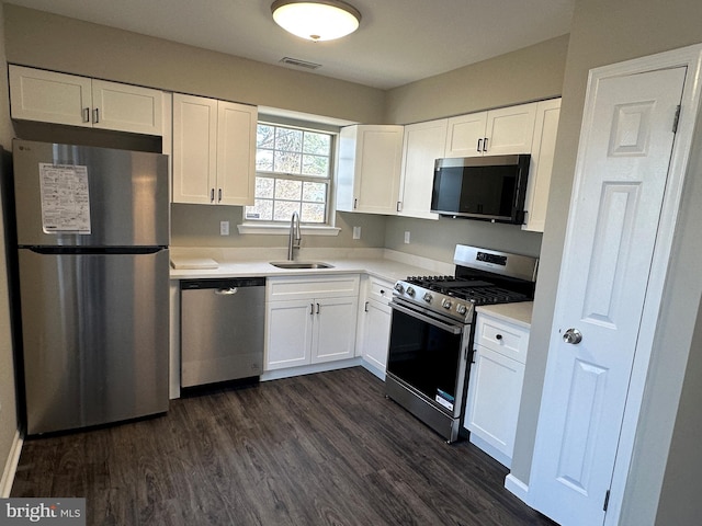 kitchen with a sink, stainless steel appliances, visible vents, and white cabinetry