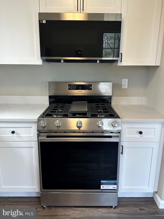 kitchen featuring dark wood-style floors, white cabinets, and stainless steel appliances