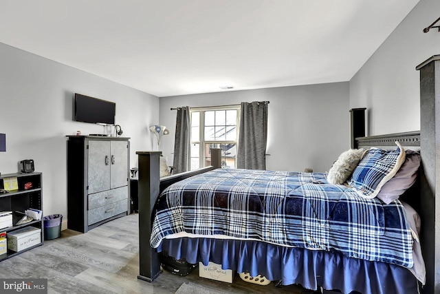 bedroom featuring visible vents and wood finished floors