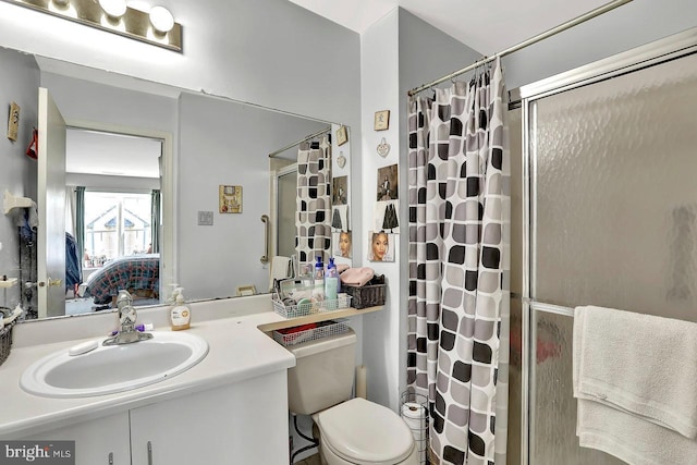 bathroom with curtained shower, vanity, toilet, and ensuite bathroom