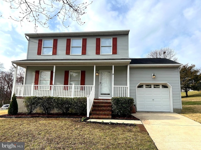 traditional home with driveway, a garage, a porch, and a front yard