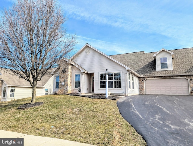 view of front of house featuring stone siding, driveway, a shingled roof, and a front lawn