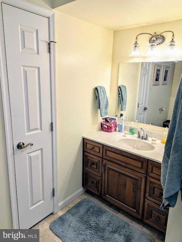 bathroom with tile patterned floors and vanity