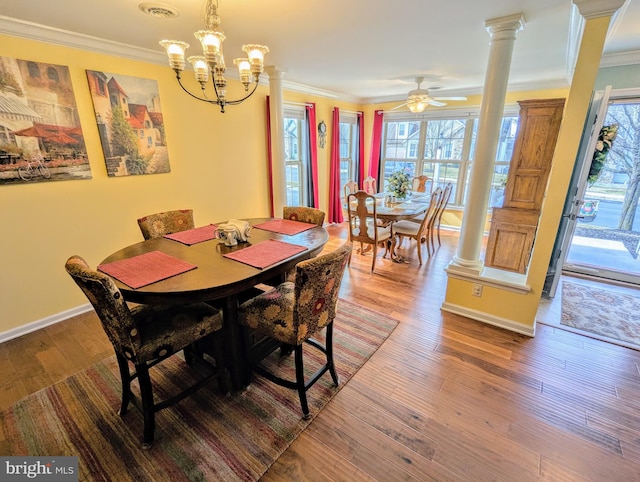 dining space with baseboards, wood finished floors, and ornamental molding