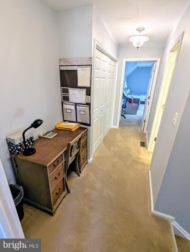 office space with visible vents, light colored carpet, and baseboards