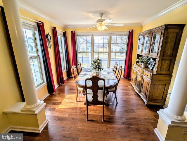 dining area featuring dark wood-style floors, a ceiling fan, and ornate columns