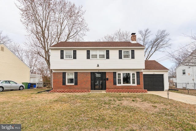 colonial home featuring driveway, a front yard, a garage, brick siding, and a chimney