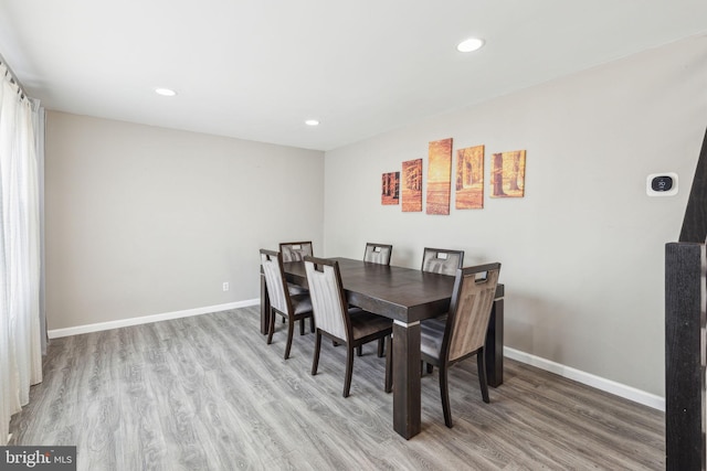 dining room featuring recessed lighting, baseboards, and wood finished floors