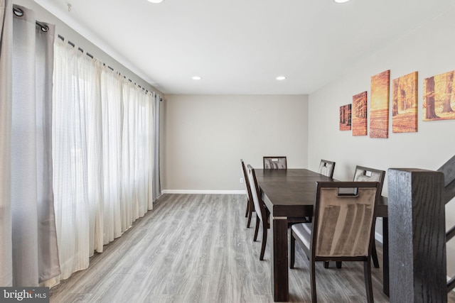 dining space featuring recessed lighting, baseboards, and light wood finished floors