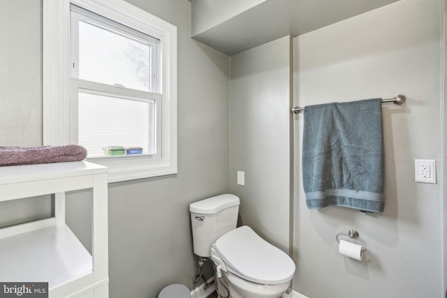 bathroom with plenty of natural light and toilet